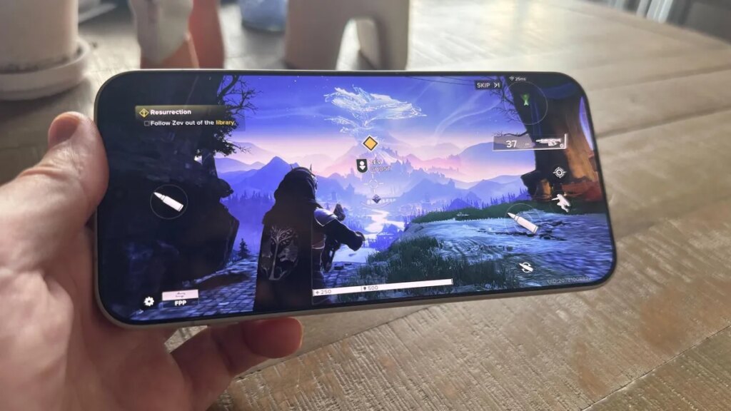 The OnePlus 15 Is One of the Best Mainstream Phones for Gamers A hand holding a phone that's playing a third-person shooter game.