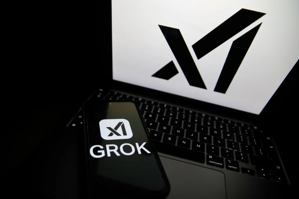India orders Musk’s X to fix Grok over ‘obscene’ AI content The Grok logo appears on a phone and the xAI logo is displayed on a laptop.