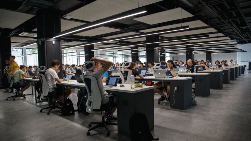 Is a ‘poor productivity climate’ killing your efficiency? Most workers say returning to the office is making us a lot less productive Office with many desks and workers at computers