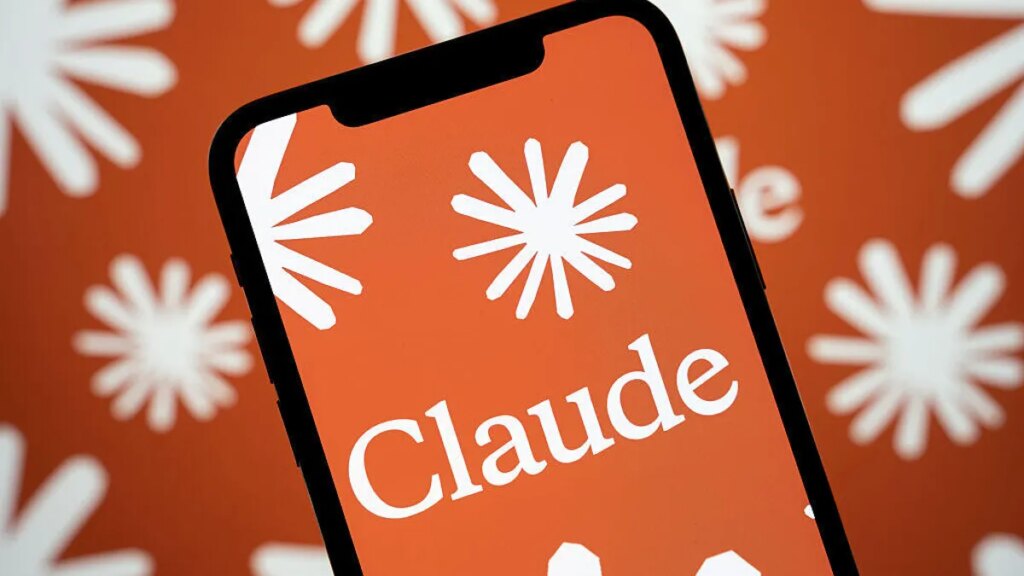 Anthropic Introduces First Design Tool to Claude The Claude AI logo is displayed on a smartphone screen with a multitude of Anthropic language model logos in the background.