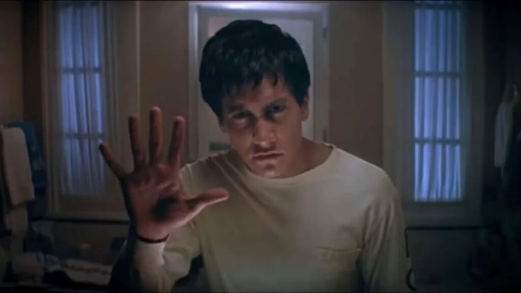 Prime Video: 12 Sci-Fi Movies You Should Stream Right Now Still from Donnie Darko showing Jake Gyllenhaal with his palm up.