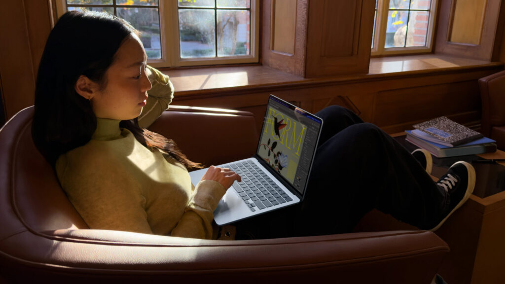 The new Apple MacBook Air M5 plummets to new record-low price Woman using Apple MacBook Air M5 in couch