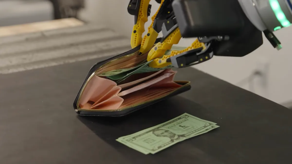 Watch a Robot Stuff Cash Into a Wallet Just Like You Do Robot hands putting money in wallet