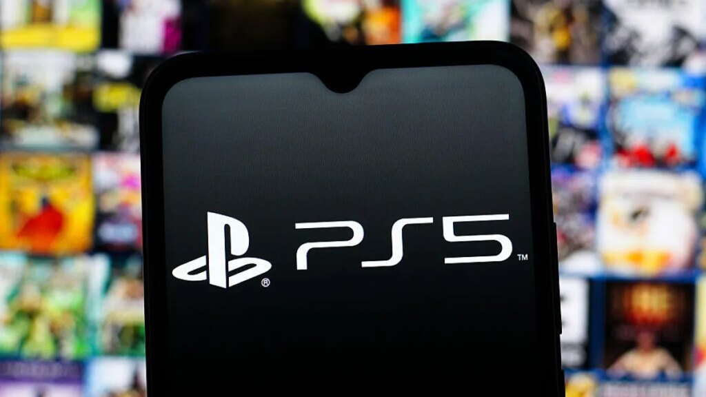 A phone with the PlayStation 5 logo is in the foreground, with blurry PlayStation-exclusive game splash art in the background.