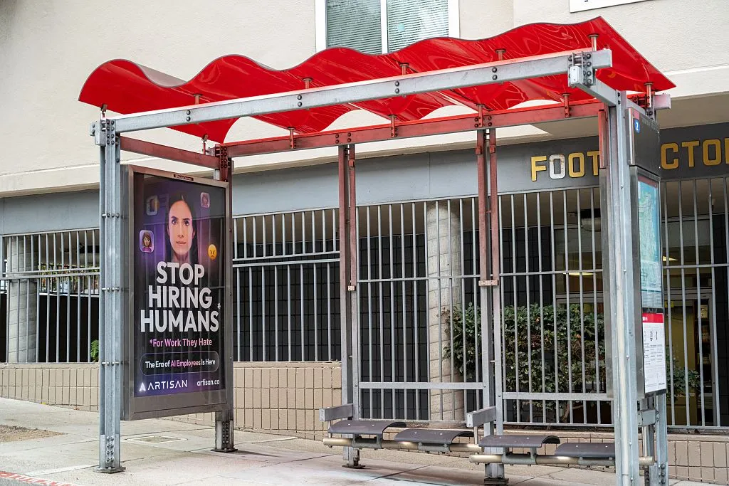 ‘This is fine’ creator says AI startup stole his art Bus stop shelter with red canopy and ad for Artisan AI reading "Stop Hiring Humans" and "For Work They Hate" on city sidewalk, San Francisco, California, September 30, 2025. (Photo by Smith Collection/Gado/Getty Images)