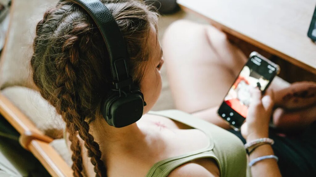 Deezer’s Free Tool Scans Your Streaming Playlists for AI-Generated Music girl-with-headphones-gettyimages-2167057002