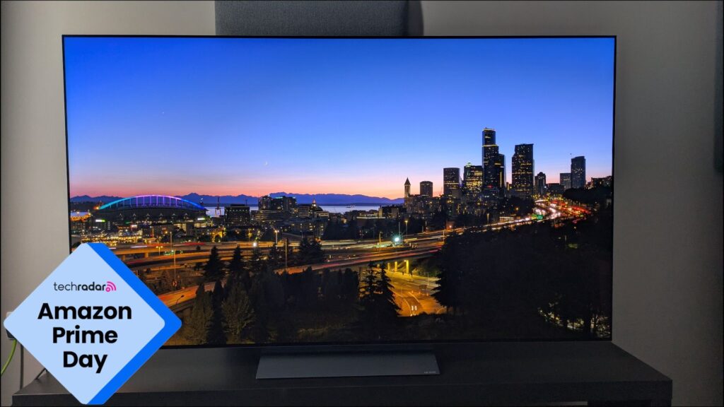 Don’t miss Prime Day’s best TV deals! I’ve picked great offers on TVs we’ve reviewed and rate highly, including OLEDs from LG and Samsung, big-screen TCL TVs and more LG C5 with sunset over city on screen with Prime Day logo in bottom left corner