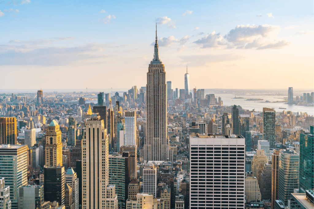 New York sports betting statements bill advances Panoramic view of the New York City skyline featuring the Empire State Building and Lower Manhattan skyscrapers during sunset, highlighting New York's financial and entertainment hub. New York advances bill requiring monthly sports betting account statements