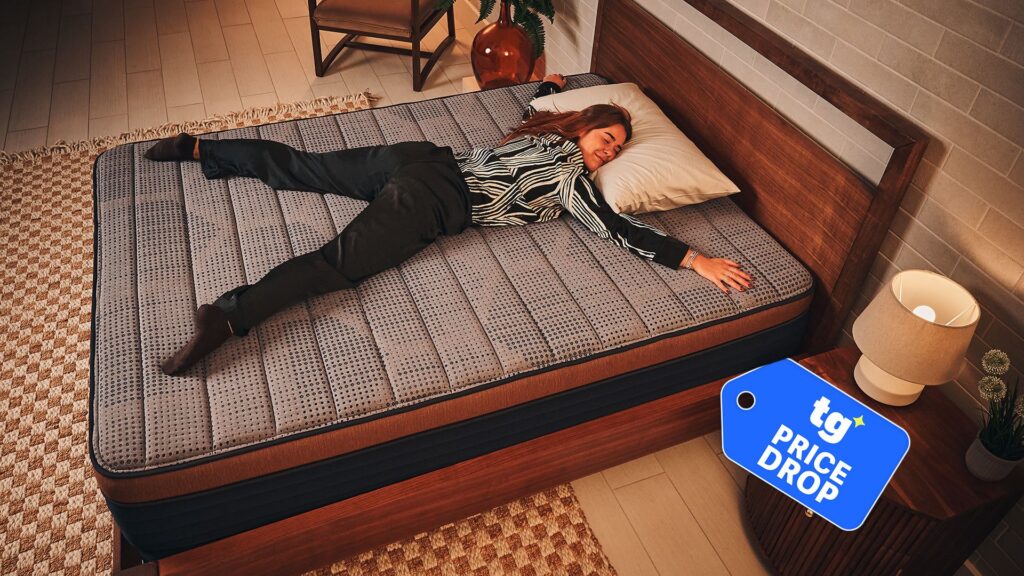 I’m a mattress deals hunter — don’t miss this value cooling bed that looks like it belongs in a luxury hotel Mattress tester Eve Davies stretches out on the Brooklyn Bedding CopperFlex Memory Foam Mattress on a bed frame in a warmly lit room. In the bottom right corner, a Tom's Guide price drop badge